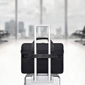 Black laptop bag with trolley strap, front logo band, and top handle