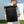 Black roll-top travel backpack with top roll closure and padded back panel