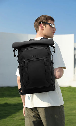 Black roll-top travel backpack with top roll closure and padded back panel