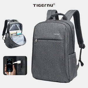 Grey compact waterproof backpack with USB charging port, front zipper pocket and side straps