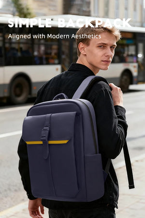 Navy waterproof commuter backpack worn by person with front buckle pocket