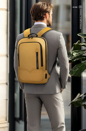 Yellow and black compact waterproof backpack worn by man with front zip pocket