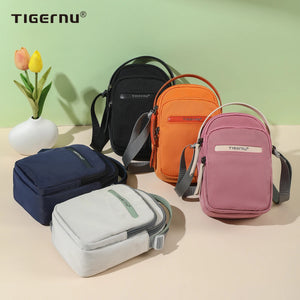 Compact crossbody bags in navy, orange, pink, and gray, shown with shoulder straps