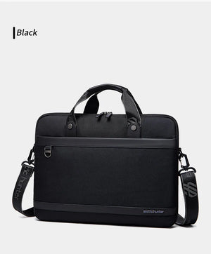 Black laptop bag with structured front, dual top handles, and crossbody strap