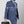 Black waterproof tech storage bag held by a person, compact zippered crossbody style