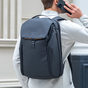 Dark waterproof backpack worn on back with front flap pocket and adjustable straps