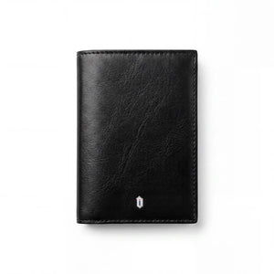 Black leather passport wallet with centered AirTag slot emblem, slim bifold front