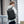 Waterproof travel backpack worn on back, black exterior with front zipper pocket