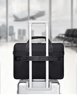 Black waterproof laptop bag with trolley handle, front zipper and side grips