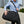 Black waterproof duffel bag worn with an adjustable shoulder strap.