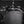Black waterproof backpack with water droplets on treated fabric surface