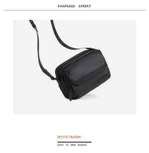 Black compact crossbody bag with flap cover, zip closure, and shoulder strap