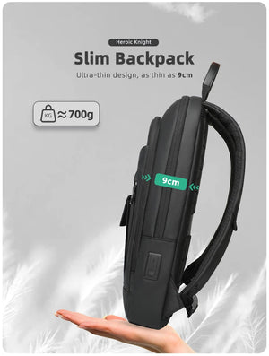 Slim black compact backpack, 9 cm profile with side handle and front pocket