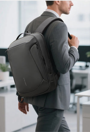 Black backpack worn in side profile with structured front panel and padded straps