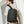 Black compact backpack worn on back with front zipper pocket and adjustable shoulder straps