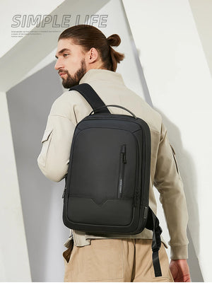 Black compact backpack worn on back with front zipper pocket and adjustable shoulder straps