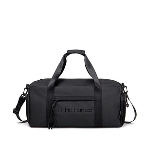 Waterproof duffel bag in black with top carry handle and detachable shoulder strap