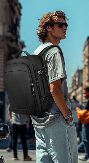 Black waterproof backpack worn on a person’s back with side zip pockets