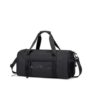 Black waterproof duffle sports bag with top handles, shoulder strap, and logo panel