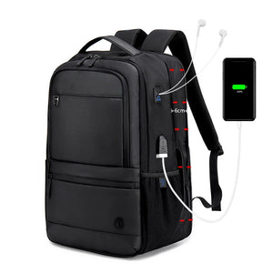 Black waterproof travel backpack with front pockets, padded straps, USB charging cable port