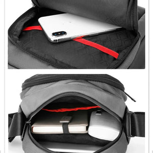 Black compact messenger bag open showing red-striped interior and zippered pockets