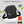 Black lightweight waterproof crossbody bag with zipper front and reinforced flap