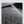 Water-resistant dark grey backpack fabric close-up with water droplets texture
