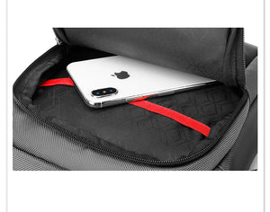 Open black messenger bag interior with red elastic strap holding a smartphone