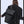 Black backpack worn from behind with top handle, shoulder straps, and back panel.