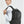 Black backpack worn on shoulders with padded straps and front zip pocket