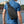 Black crossbody chest bag worn on the back with side zip pocket detail