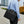 Black waterproof laptop bag on shoulder strap, front pocket with metal zipper