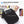 Black crossbody messenger bag with back stealth pocket and front phone storage opening