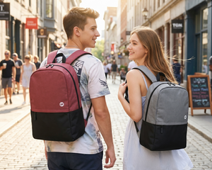 Two people walking down a street, each carrying a backpack.
